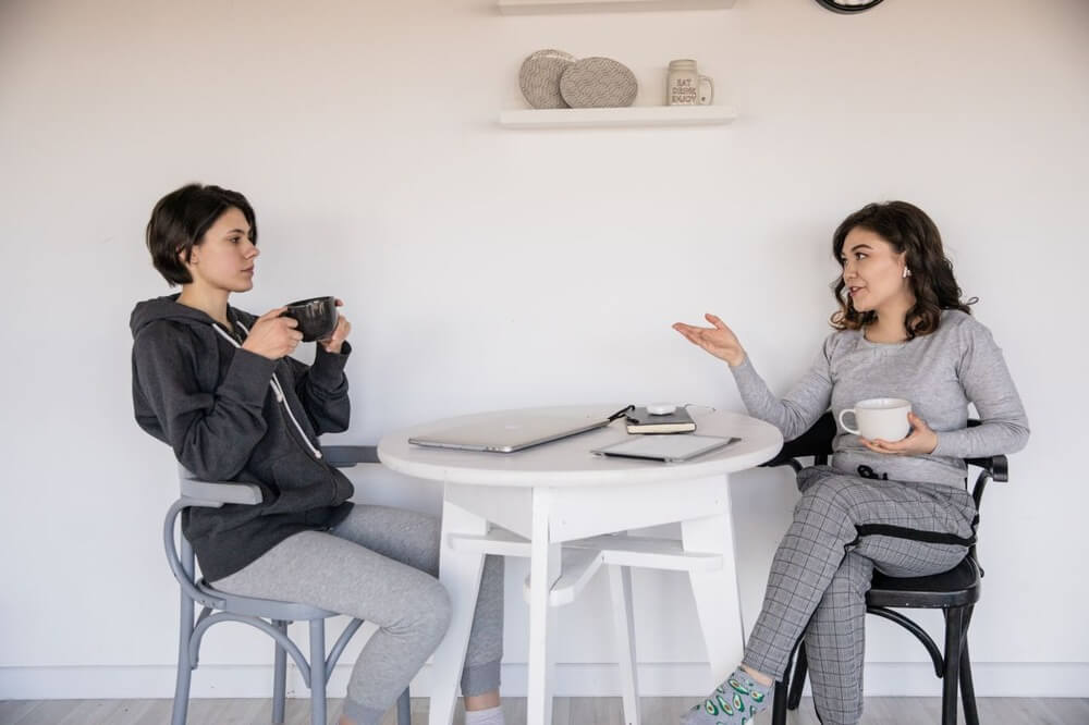 Two people sitting down having a conversation