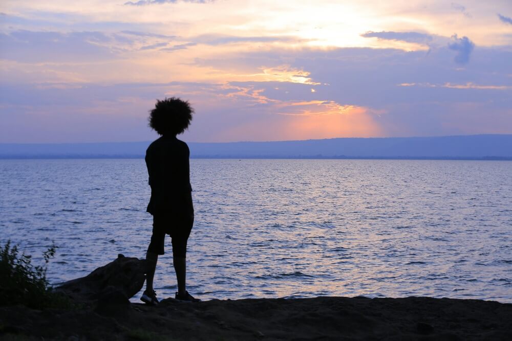 A silhouette of a girl looking out to sea