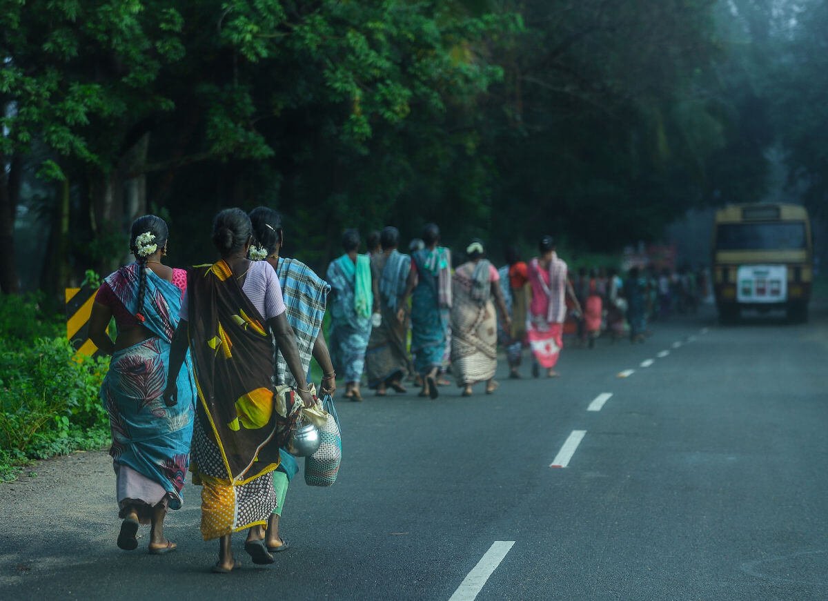 People walking on the side of the road in Tamil Nadu, India