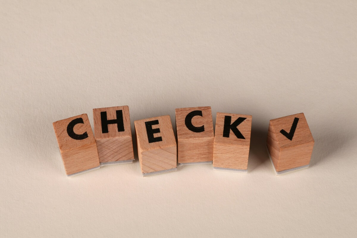 Wooden letter blocks spelling the word check