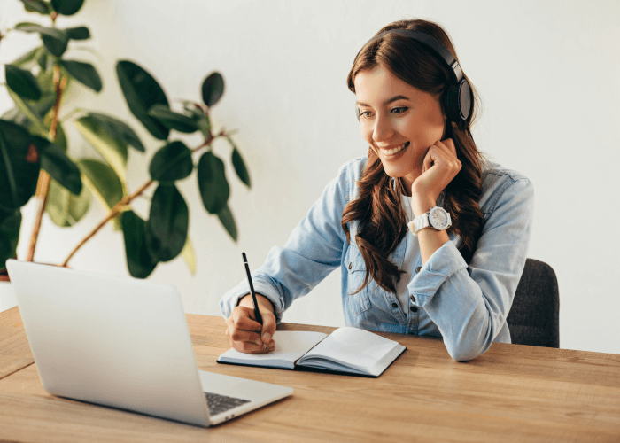 A smiling woman learning English online